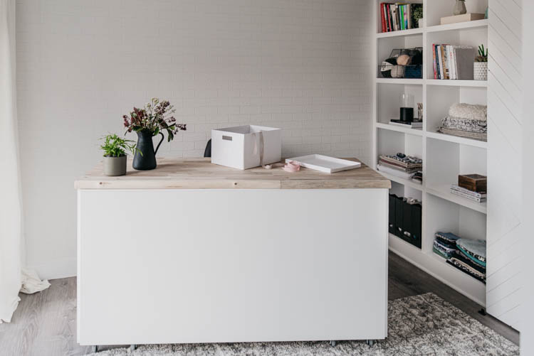 beautiful bright white craft studio in a basement