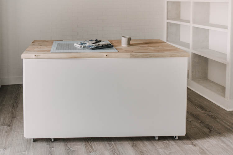 DIY Rolling craft table with front panel to conceal the seating and hidden storage