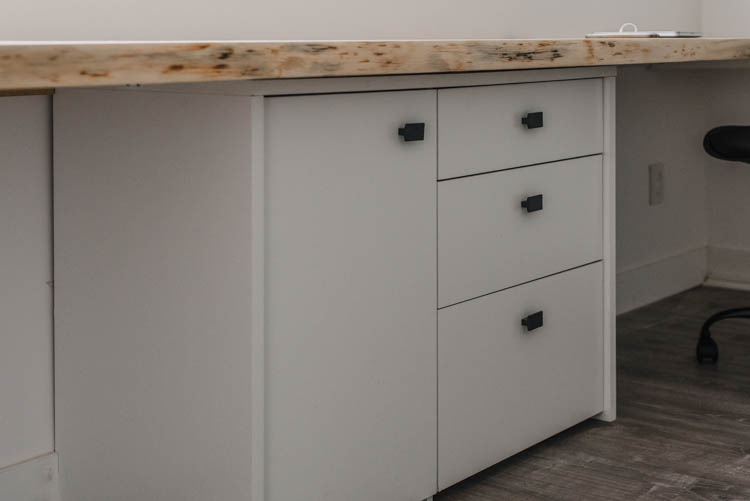 Long desk sits on filing cabinet for support and storage