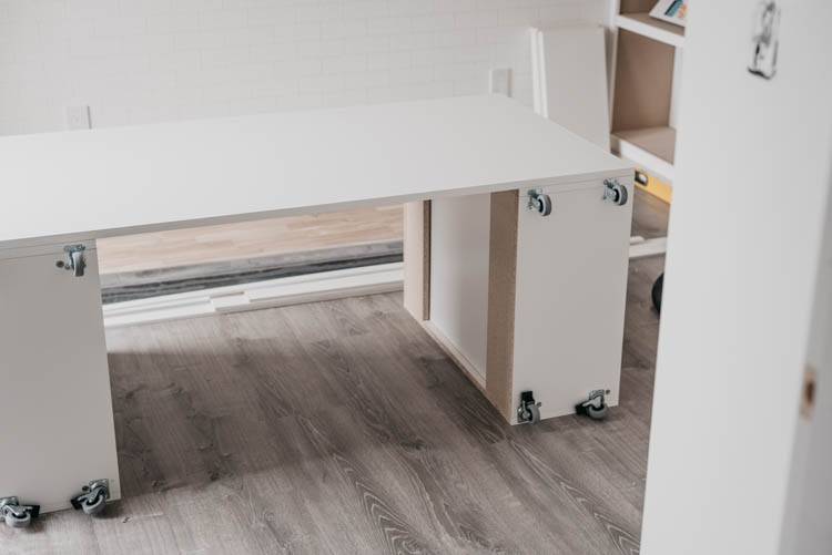 DIY Rolling craft table made from affordable kitchen cabinets!