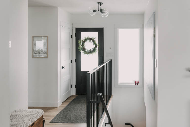 Modern decor in a small entryway... those sweet elves on the window!