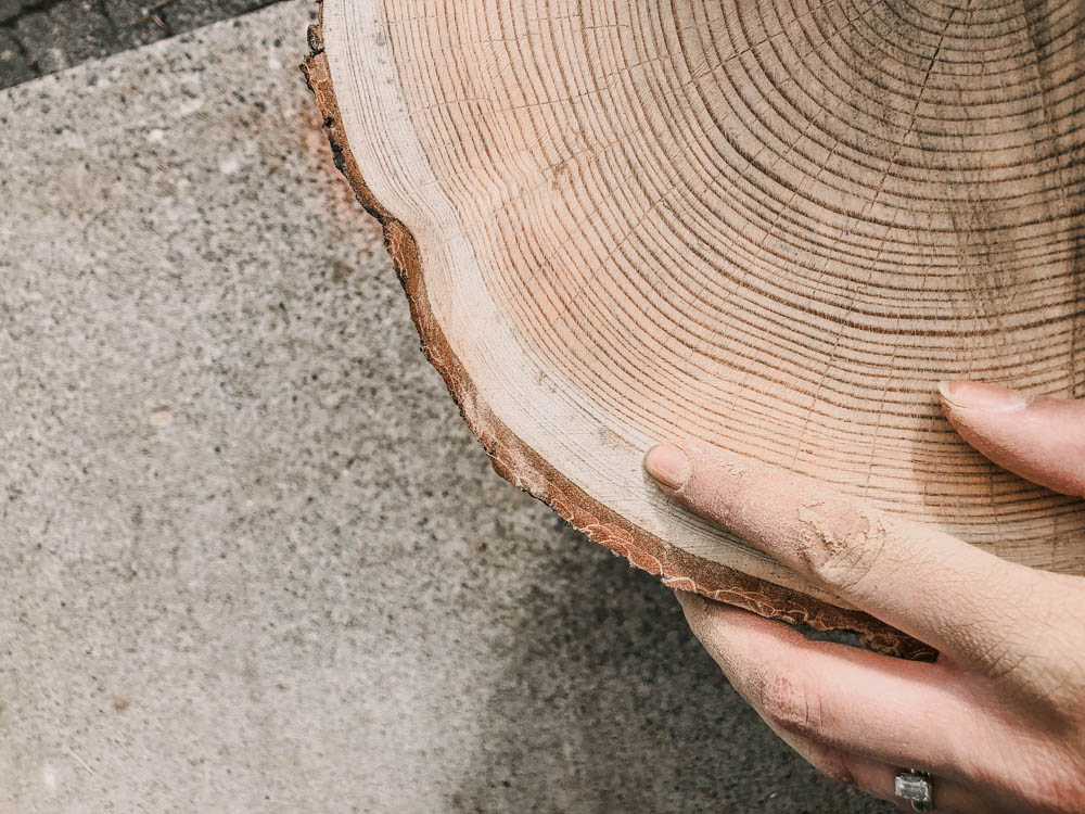 sanding down wood stumps for tree ring art