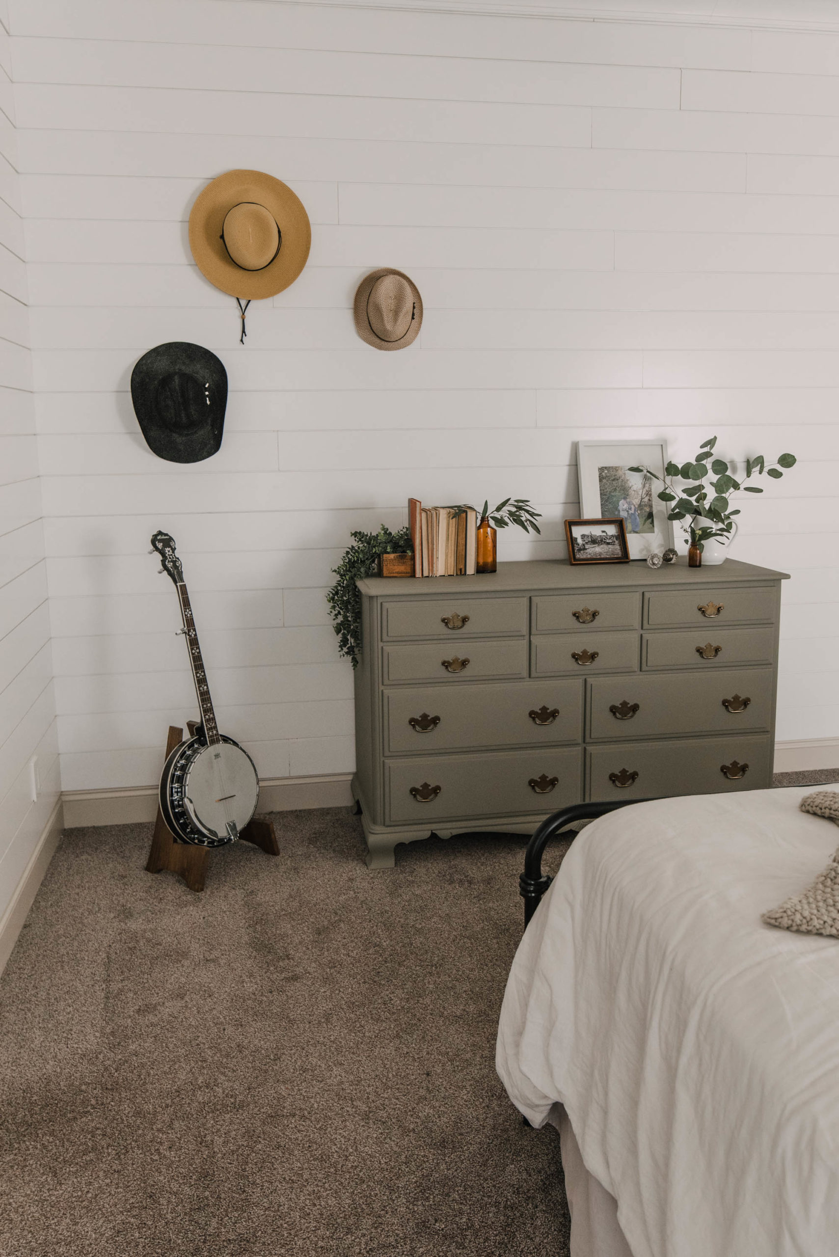 Green Painted dresser with hat wall in a shiplap bedroom (actually a mobile home!)