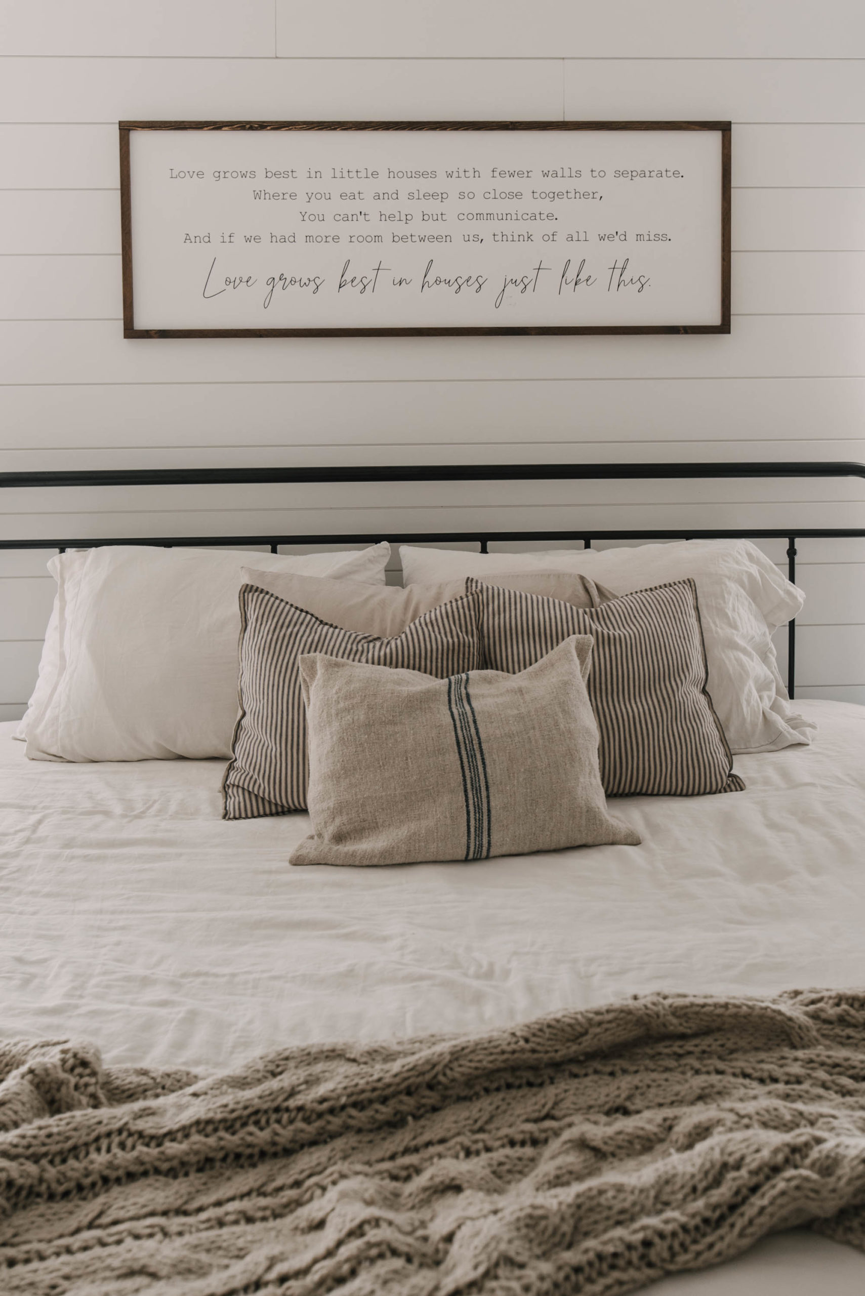Farmhouse bedroom decor with wooden sign