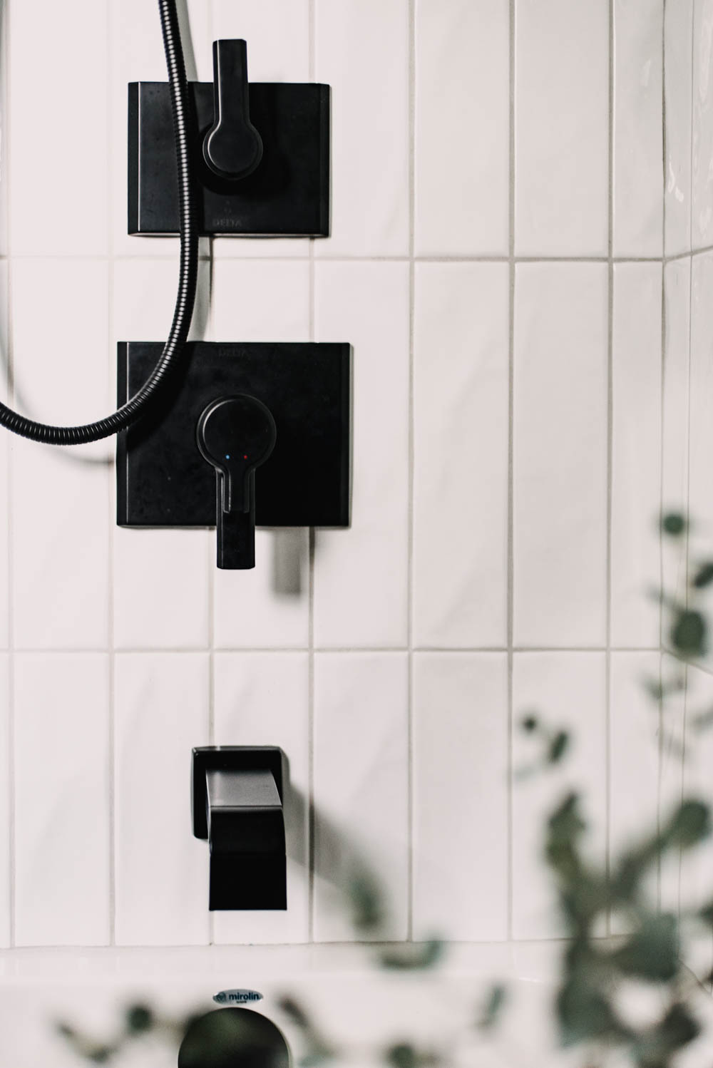 Modern black fixtures for a tub shower combo