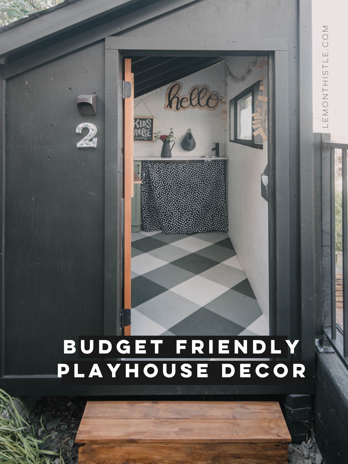 Budget friendly playhouse decor, text over image of black modern playhouse with buffalo check floor and green cabinet mini kitchen