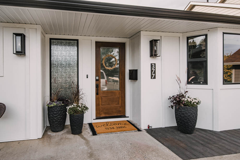 Modern ranch house entryway with black and white and warm wood tones