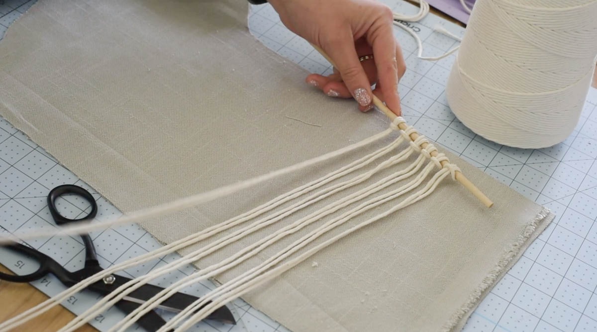 Larks head knot to attach macrame cord to the dowel