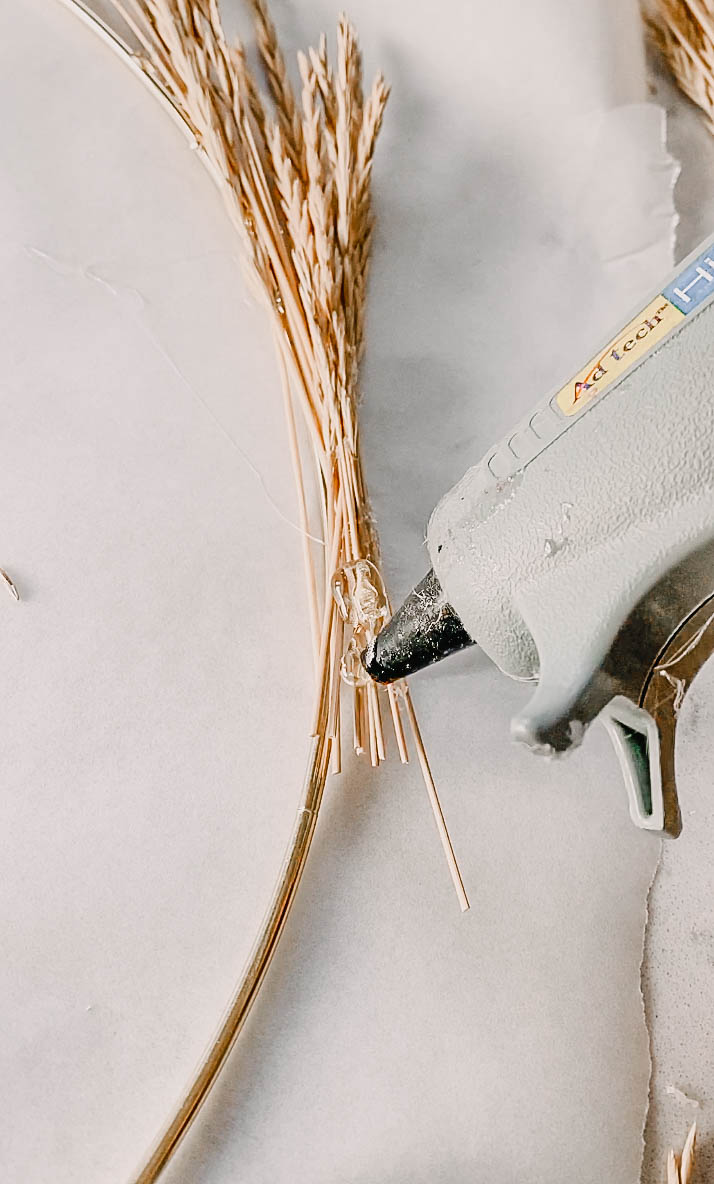 hot glue wild grass to brass hoop