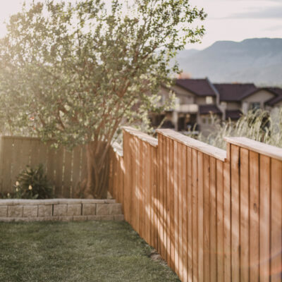 Staining a fence with a paint sprayer