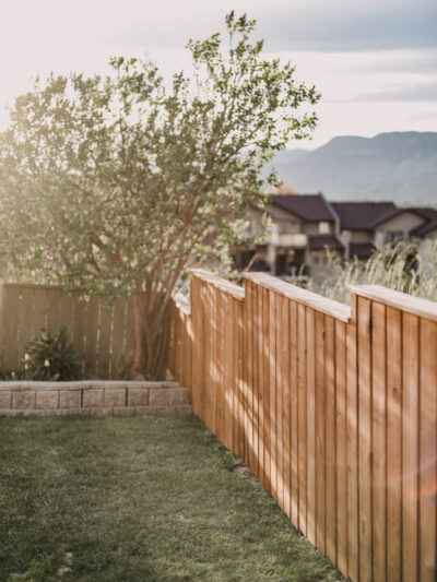 Staining a fence with a paint sprayer