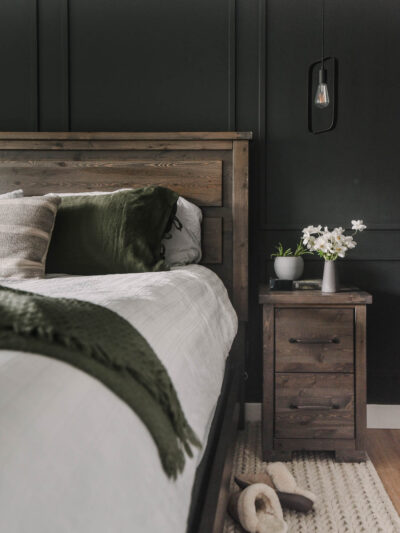 Black bedroom with wood furniture