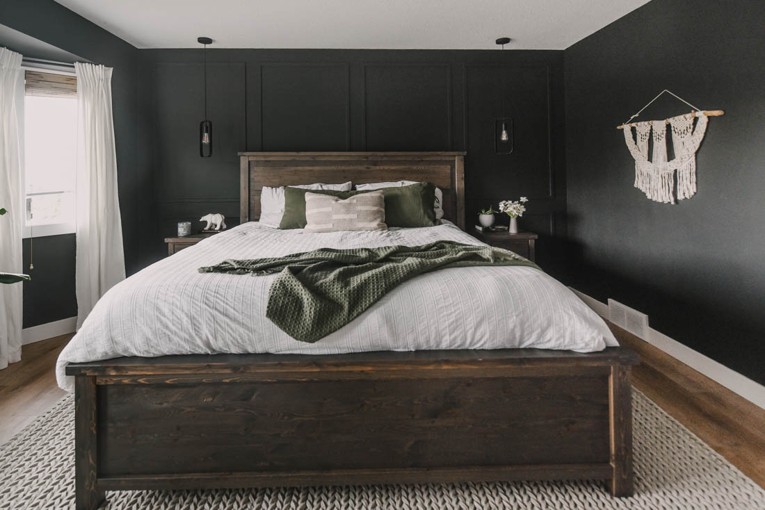 Black bedroom with wood furniture