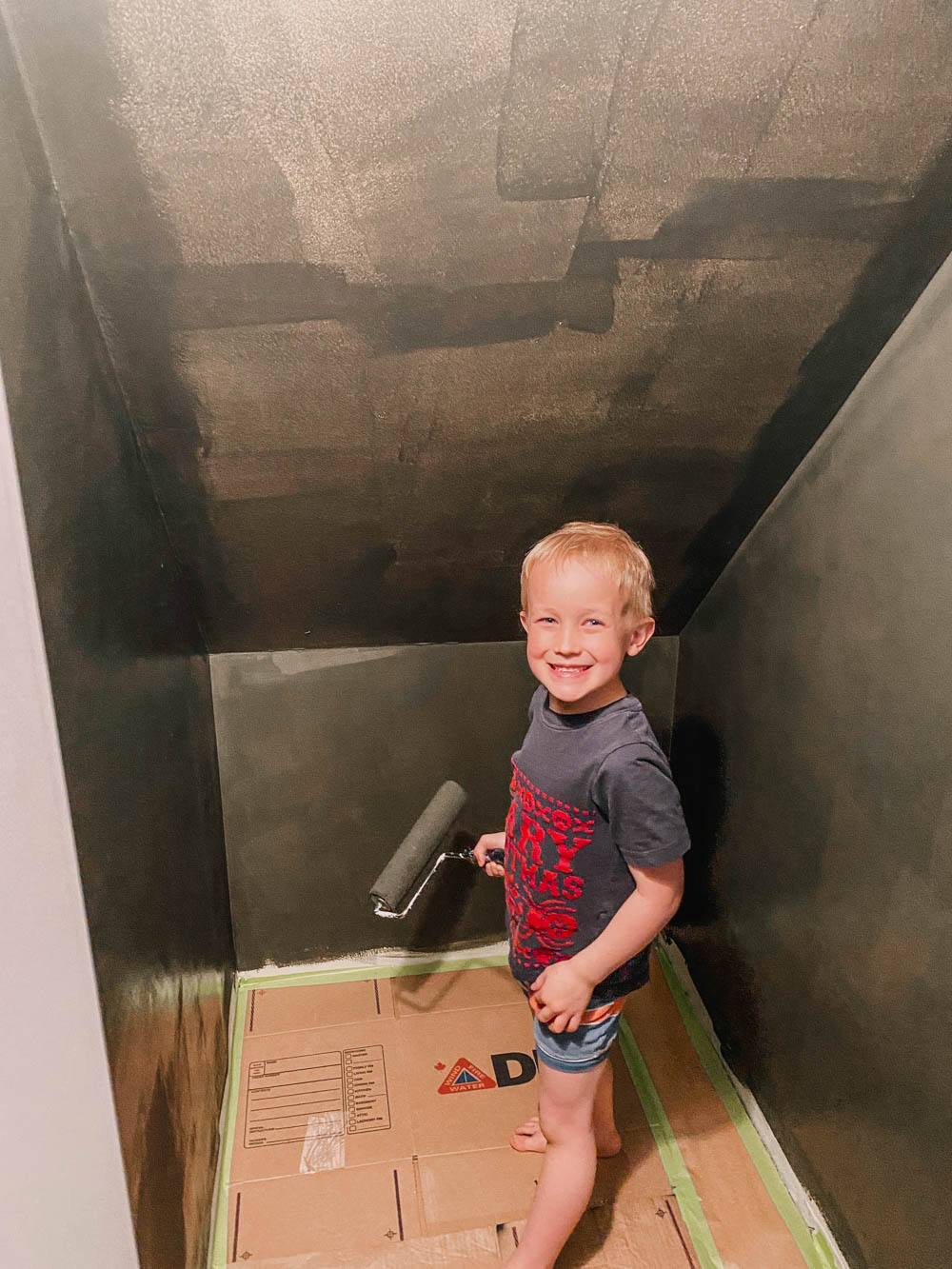 Kids Helping Paint under stairs to dress up nook