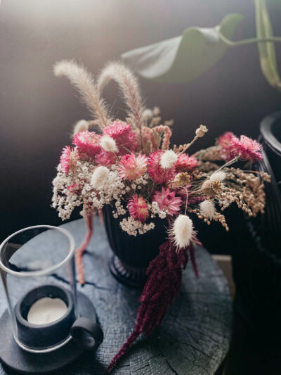 dried floral arrangement with pink strawflowers and bunny tail grasses