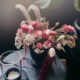 dried floral arrangement with pink strawflowers and bunny tail grasses