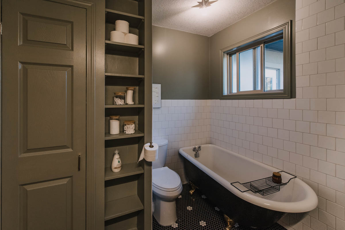 DIY Bathroom makeover with green walls and black tile floors