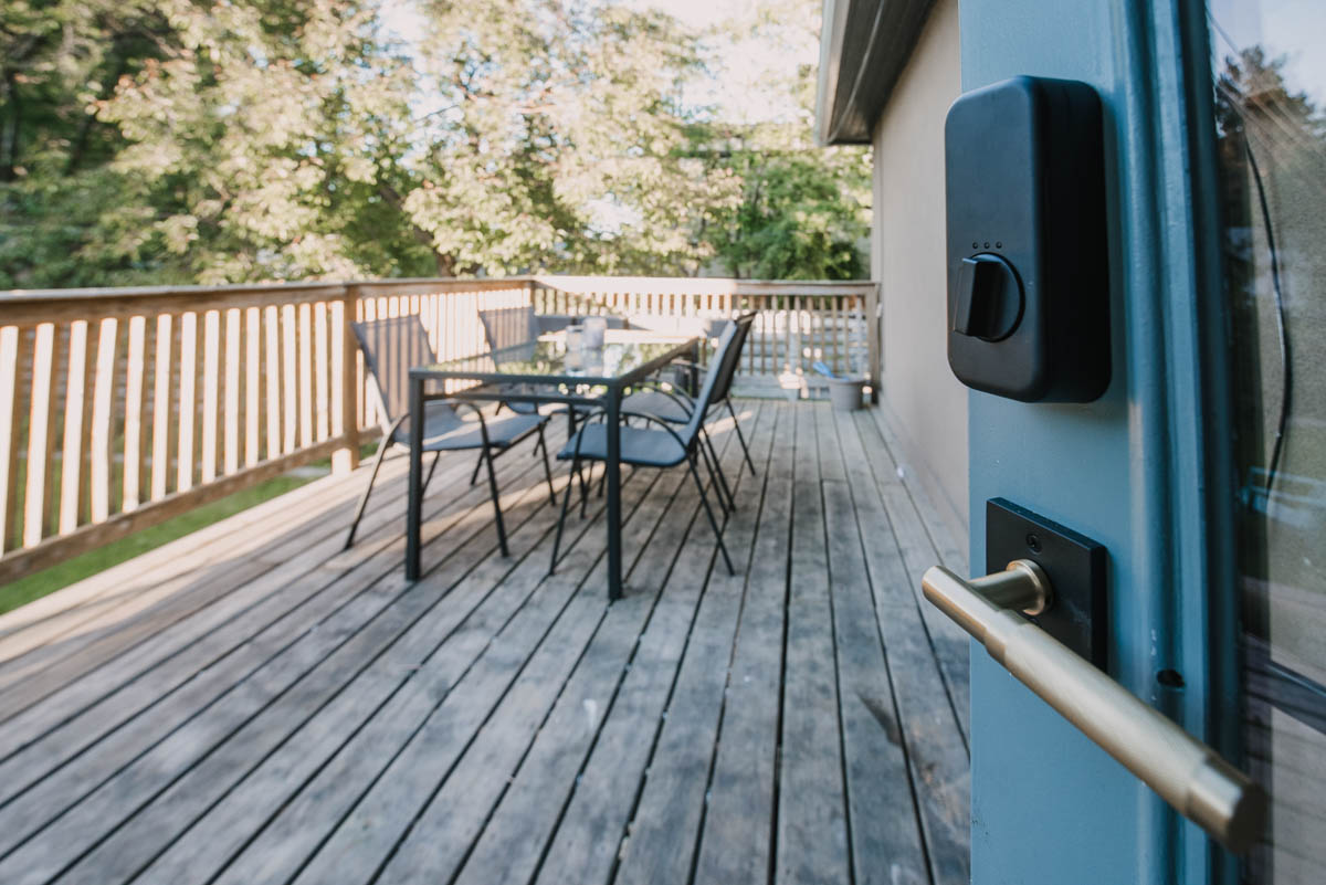 Gold handle on smart lock to patio