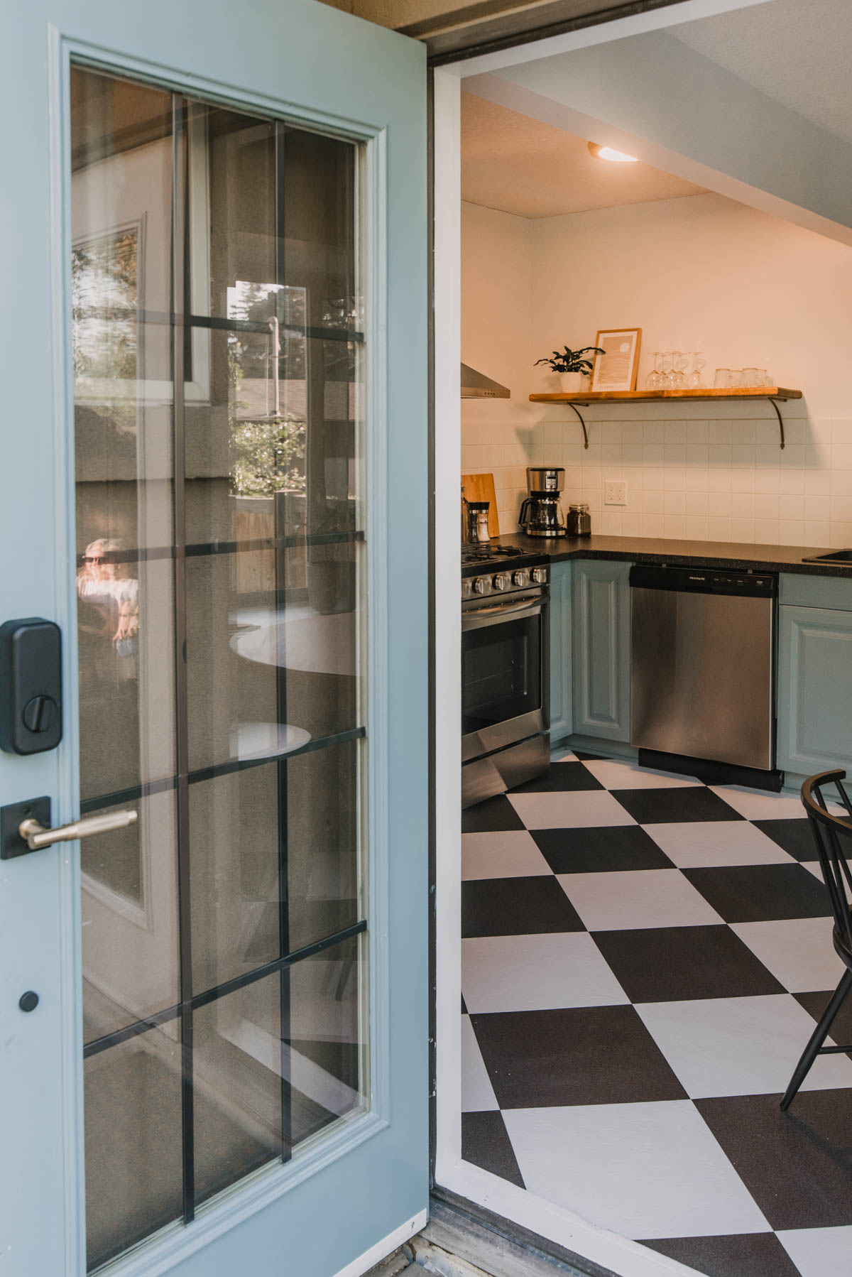 Blue door into a blue kitchen
