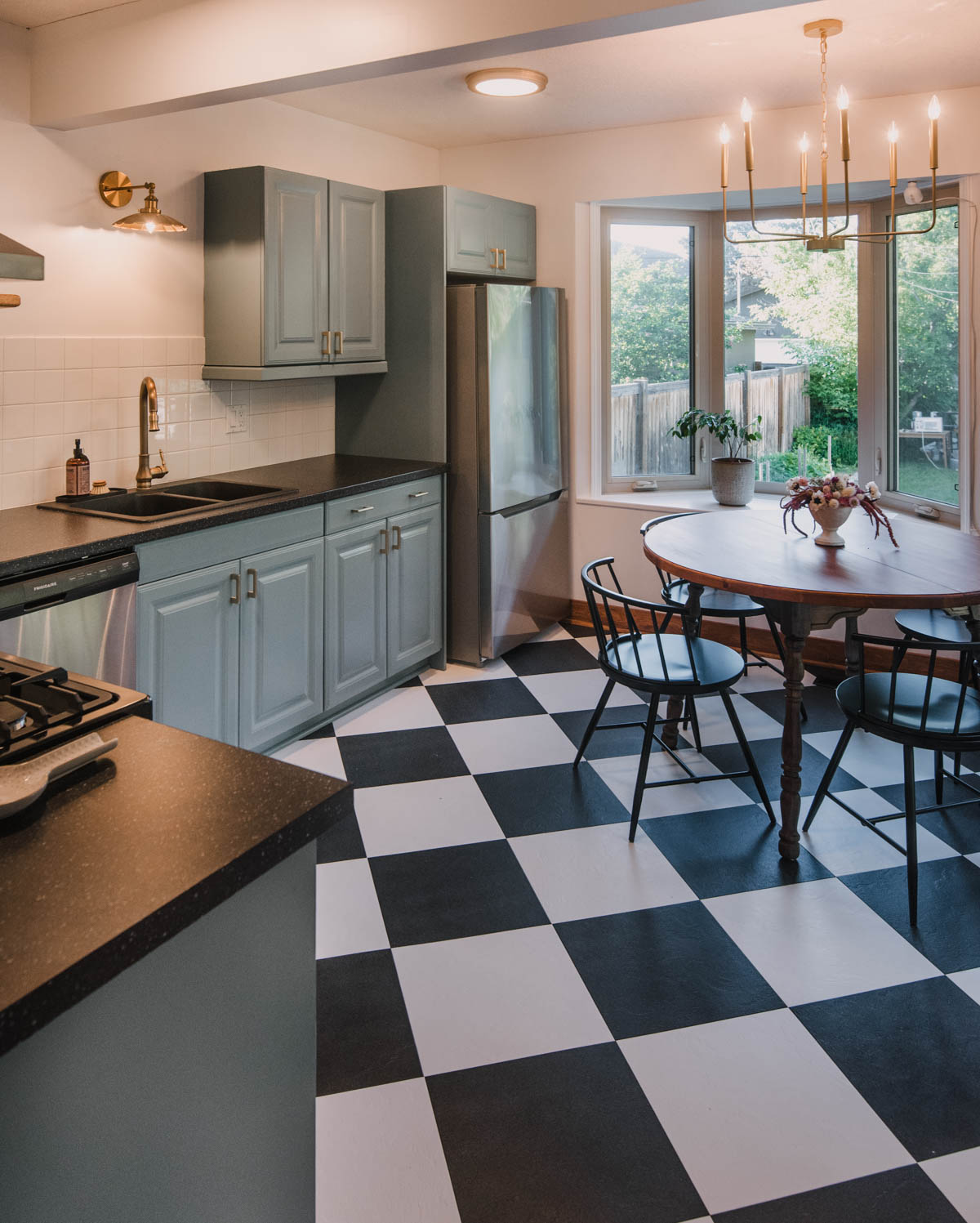 Blue cabinets with checkerboard floors in this kitchen remodel