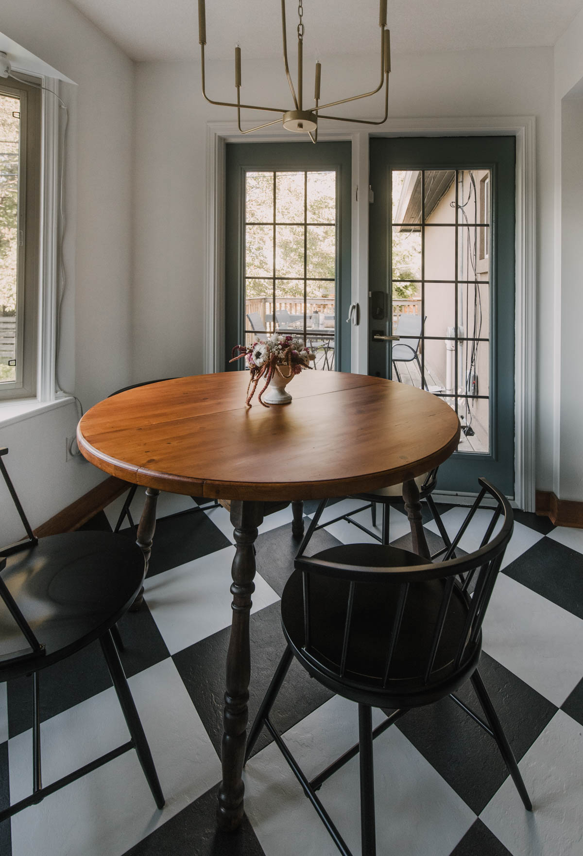 charming dine in area in a checkerboard blue kitchen
