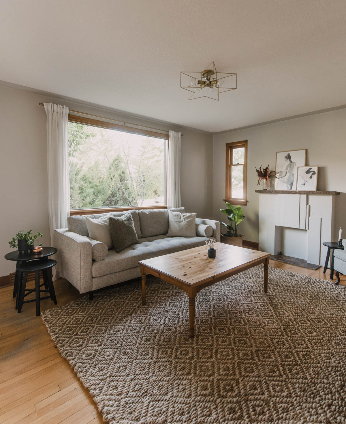 Inviting taupe living room makeover with brass star light and thrifted furniture