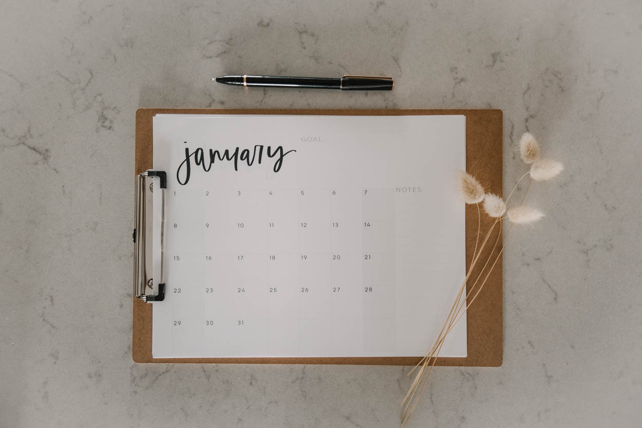 printable calendar on clipboard with pen- modern black and white hand lettered grid calendar