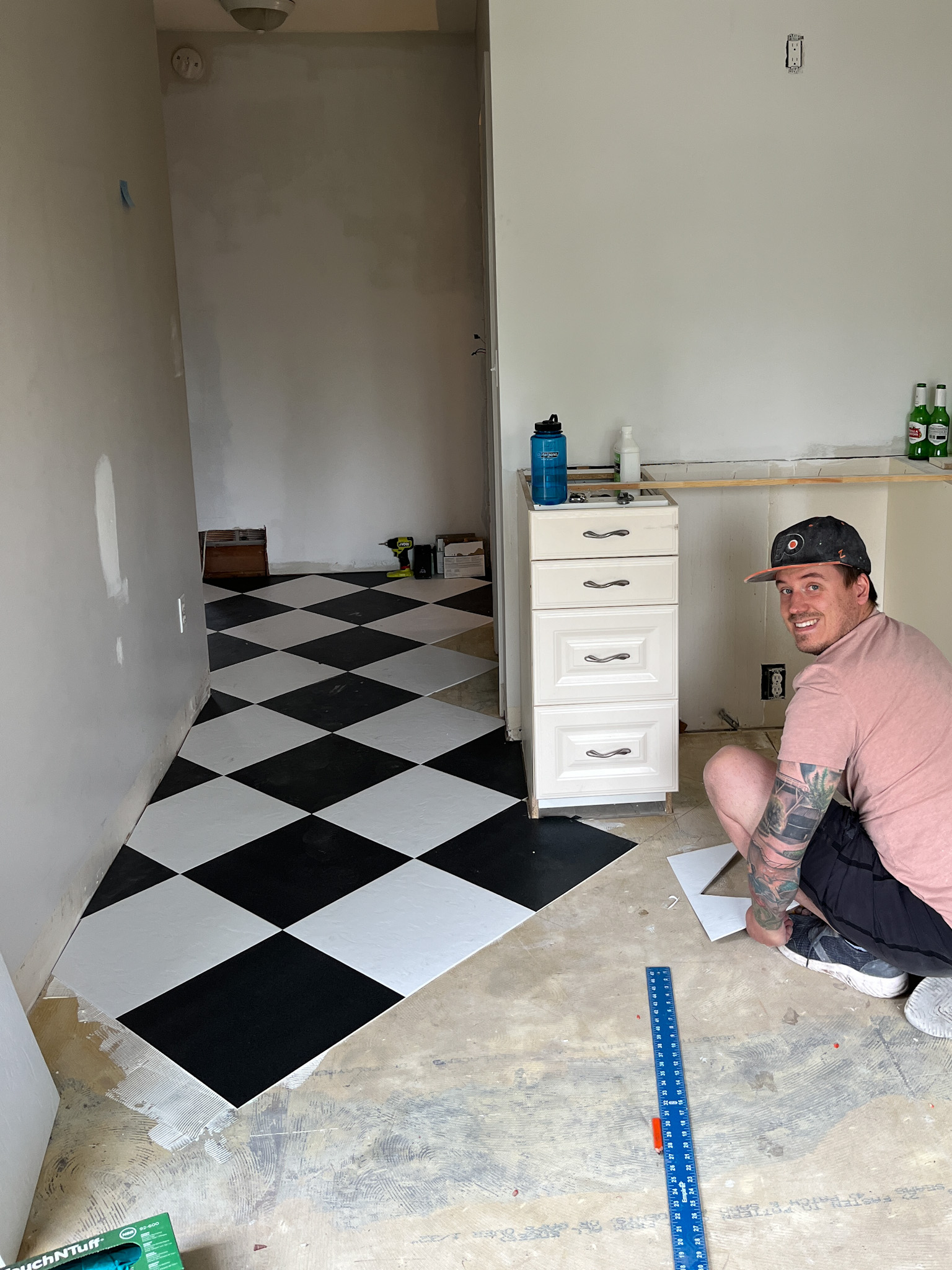 laying VCT checker board flooring
