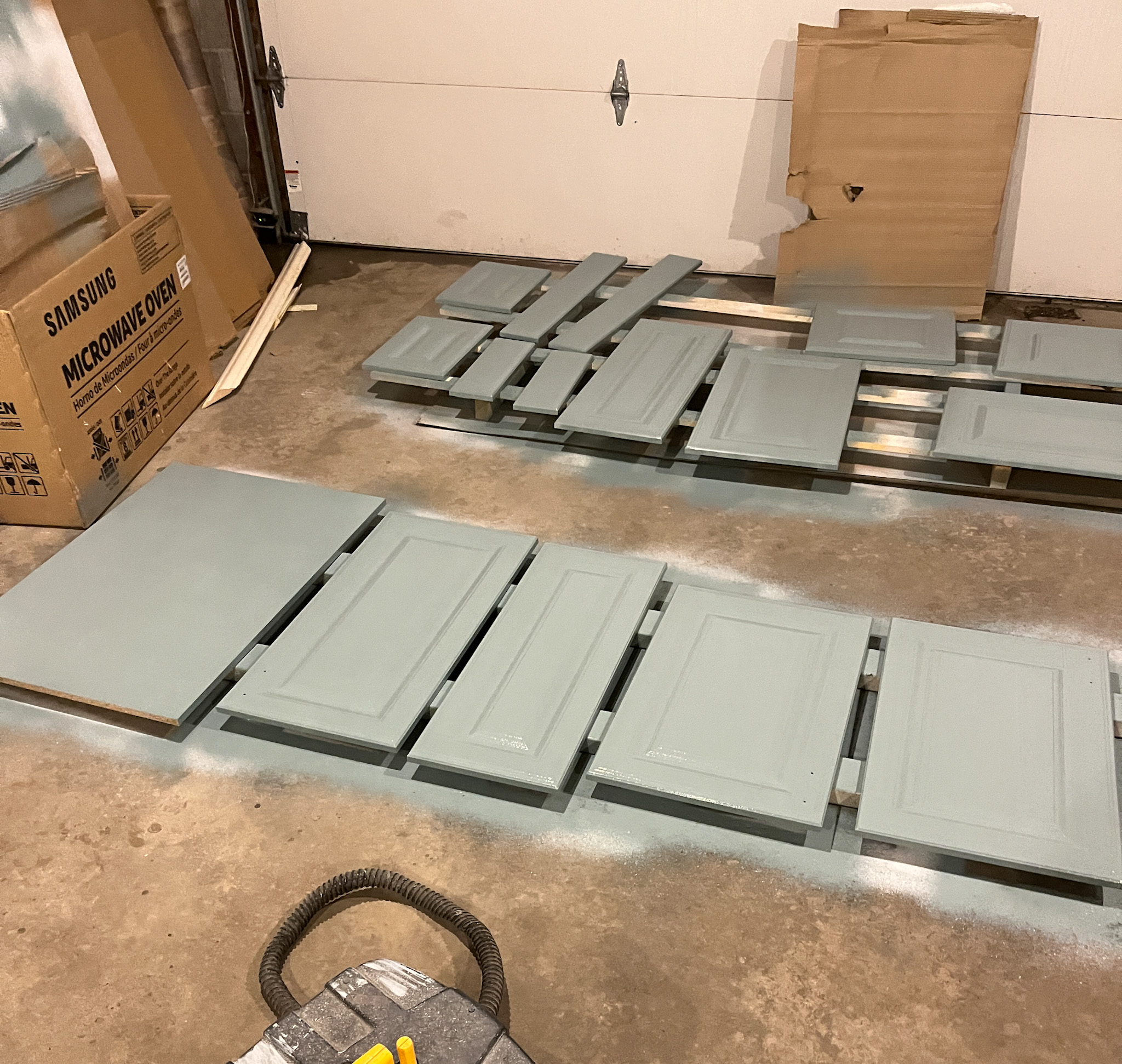 Painting cabinet doors blue with a sprayer