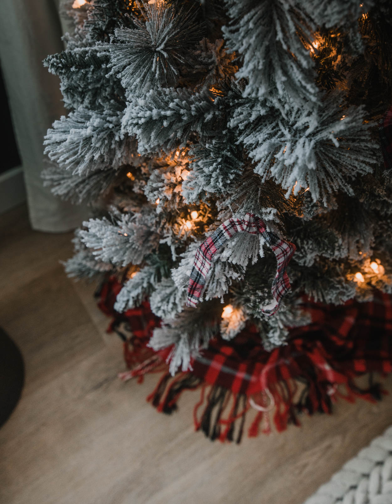 Skinny flocked tree with plaid ribbon decor