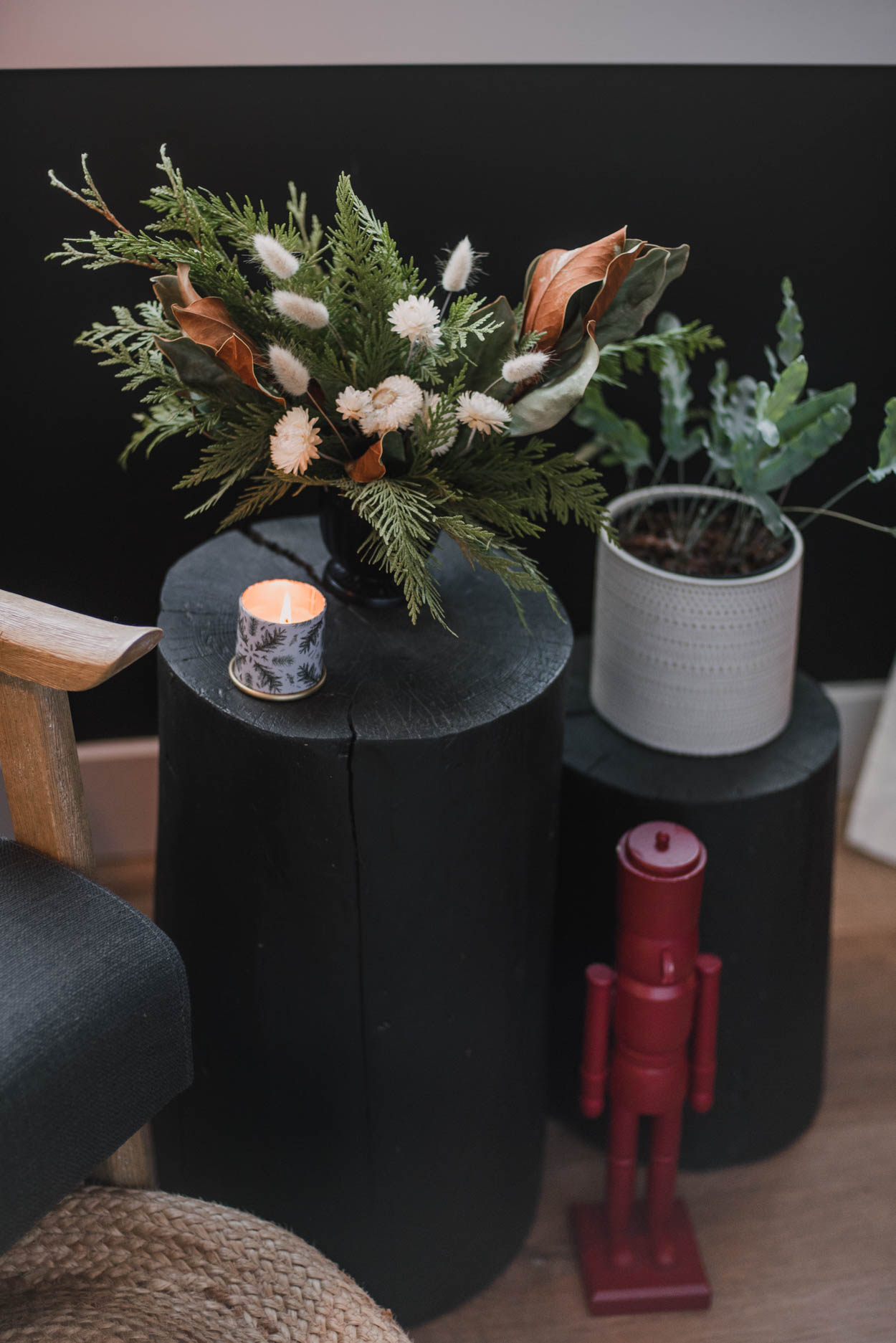 Holiday bedroom decor - bay window sitting area with log tables, nutcracker and holiday floral arrangement