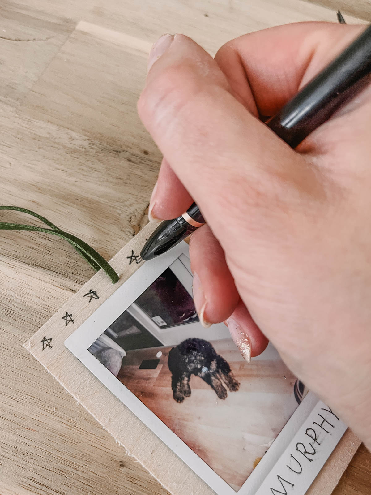 Scandi inspired photo ornaments using instax photos and black ink details on wood