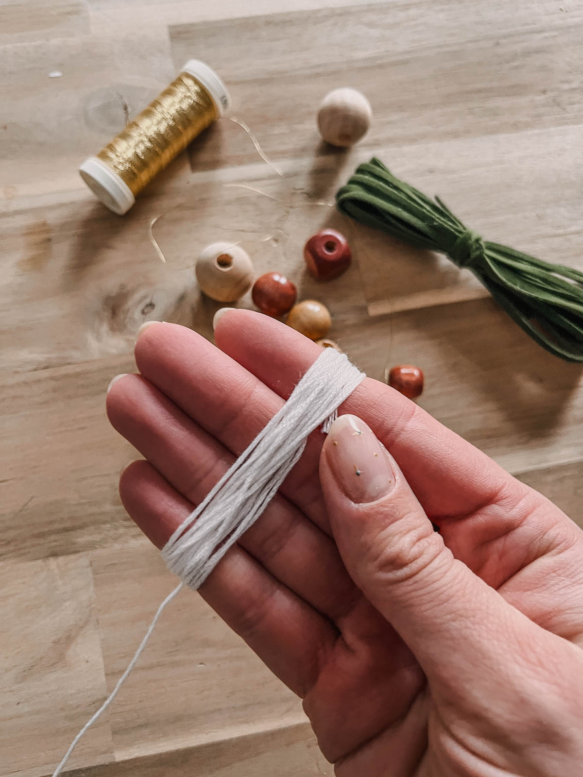 DIY Tassel Ornaments from dollar store supplies, image of making a tassel