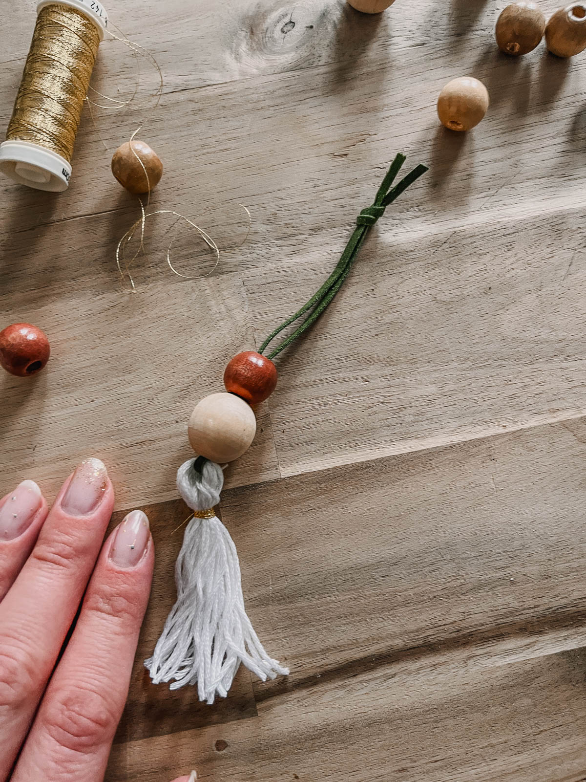 simple christmas ornament with wooden beads and a tassel