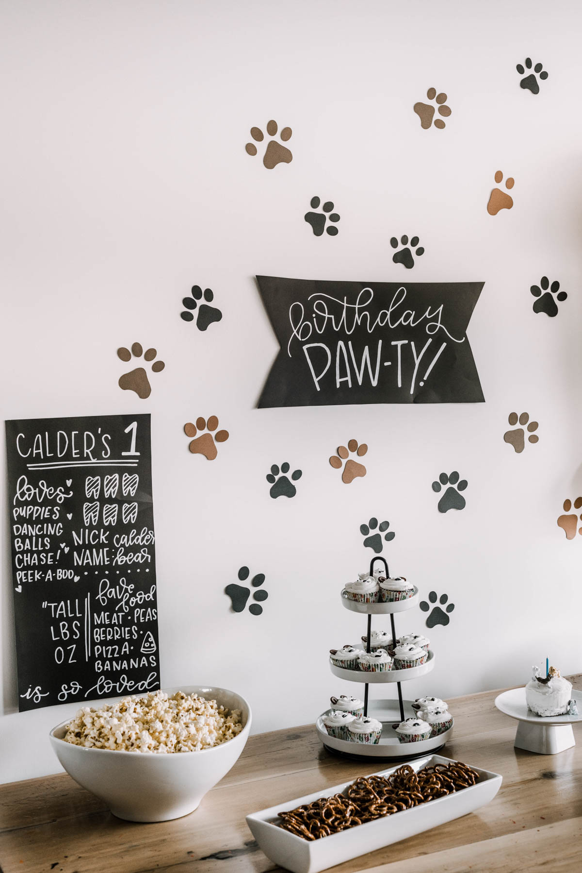 First birthday party with a puppy theme- paw prints backdrop and puppy balloon