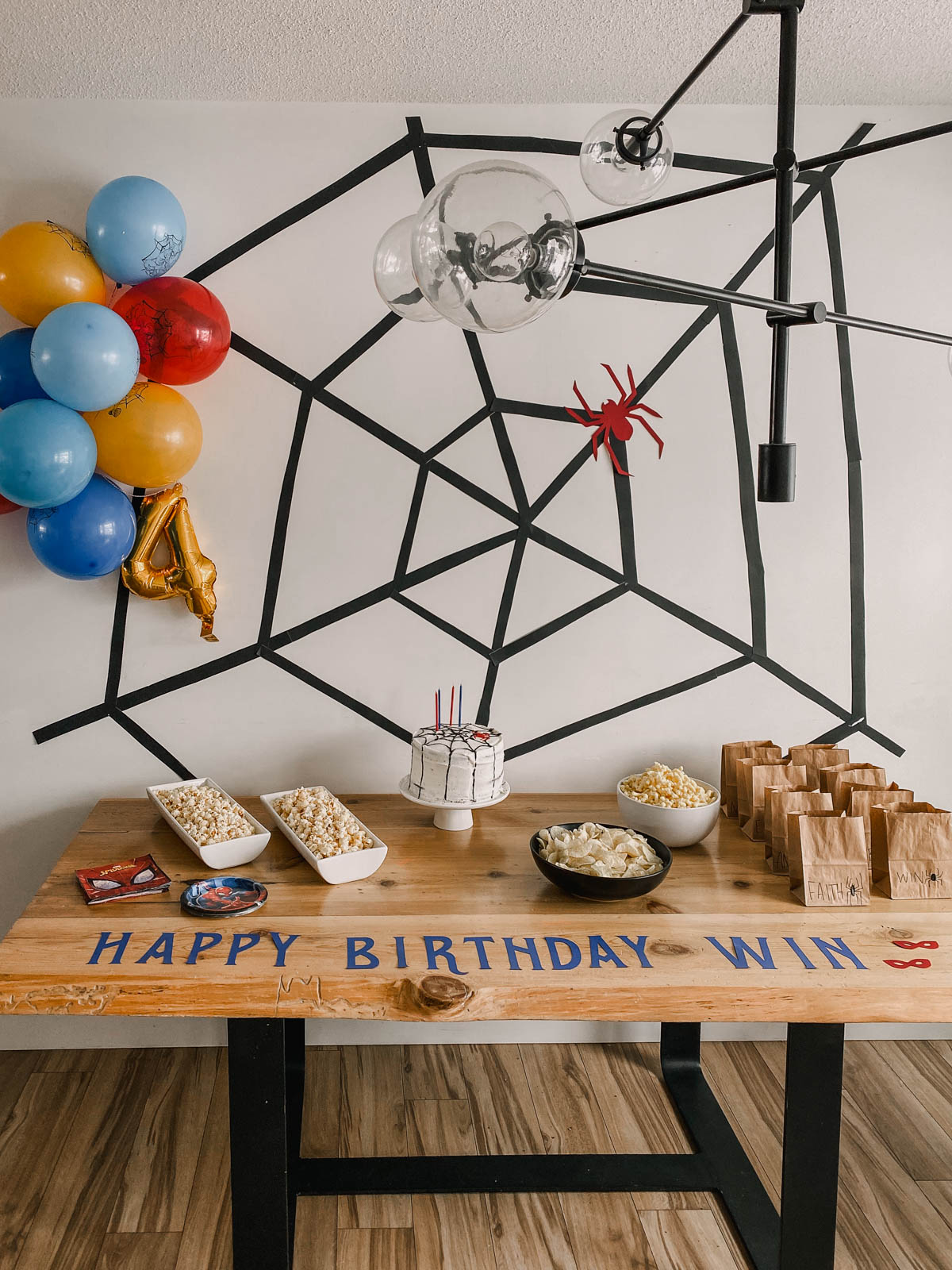 DIY spiderman themed birthday party decor- large spiderweb behind party table
