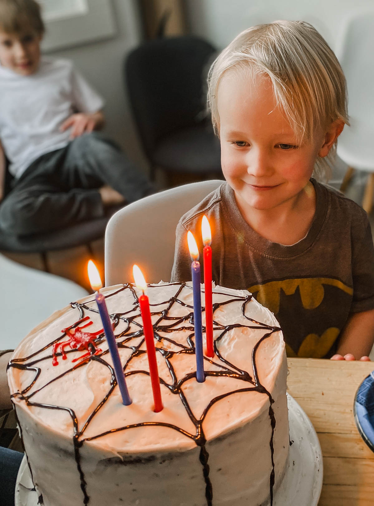 DIY spiderman themed birthday cake- candles being blown out