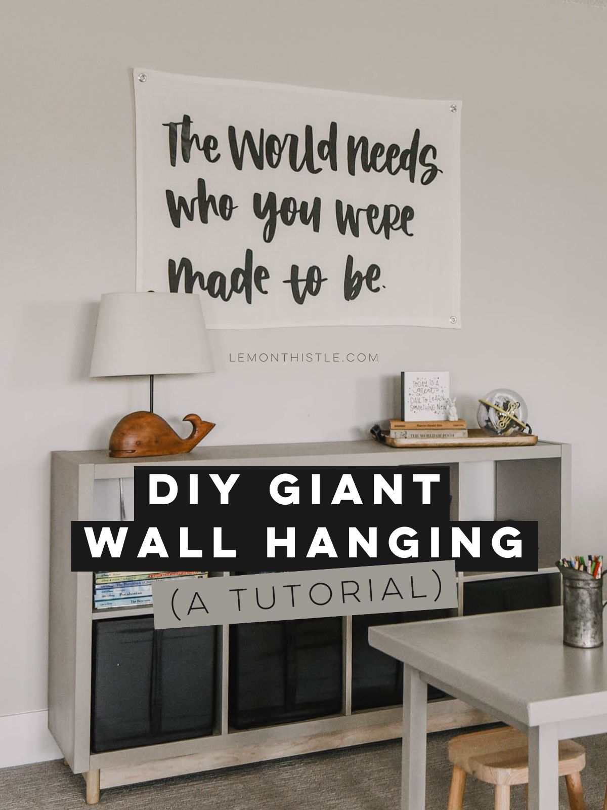 giant wall hanging that says 'the world needs who you were made to be' in playroom. Text over reads: DIY giant wall hanging (a tutorial)