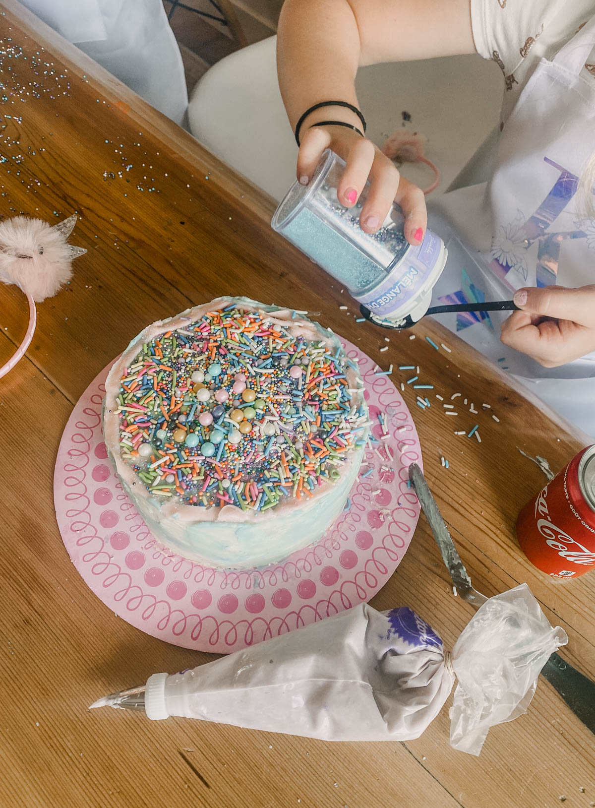 kids decorating a cake at a cake decorating party