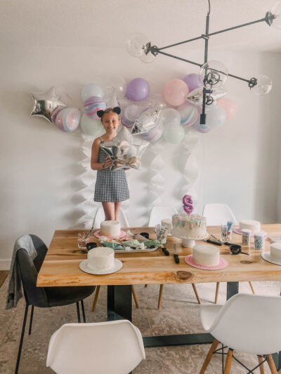 DIY Cake Decorating Party with pastel balloons and white fringe garlands