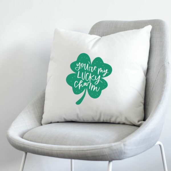 'you're my lucky charm' hand lettered on a shamrock ironed on to a white pillow