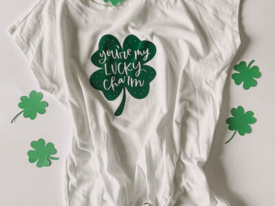 'you're my lucky charm' hand lettered on a shamrock ironed on to a tee shirt