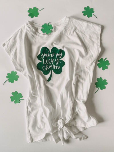 'you're my lucky charm' hand lettered on a shamrock ironed on to a tee shirt