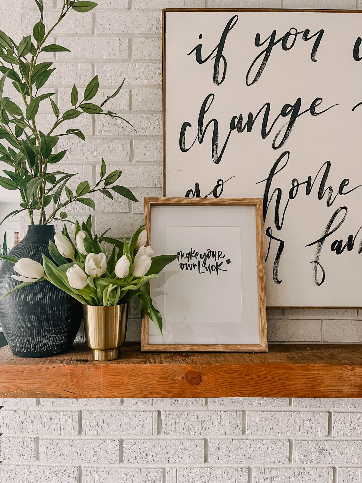 'make your own luck' free hand lettered black and white printable in frame on mantel beside tulips