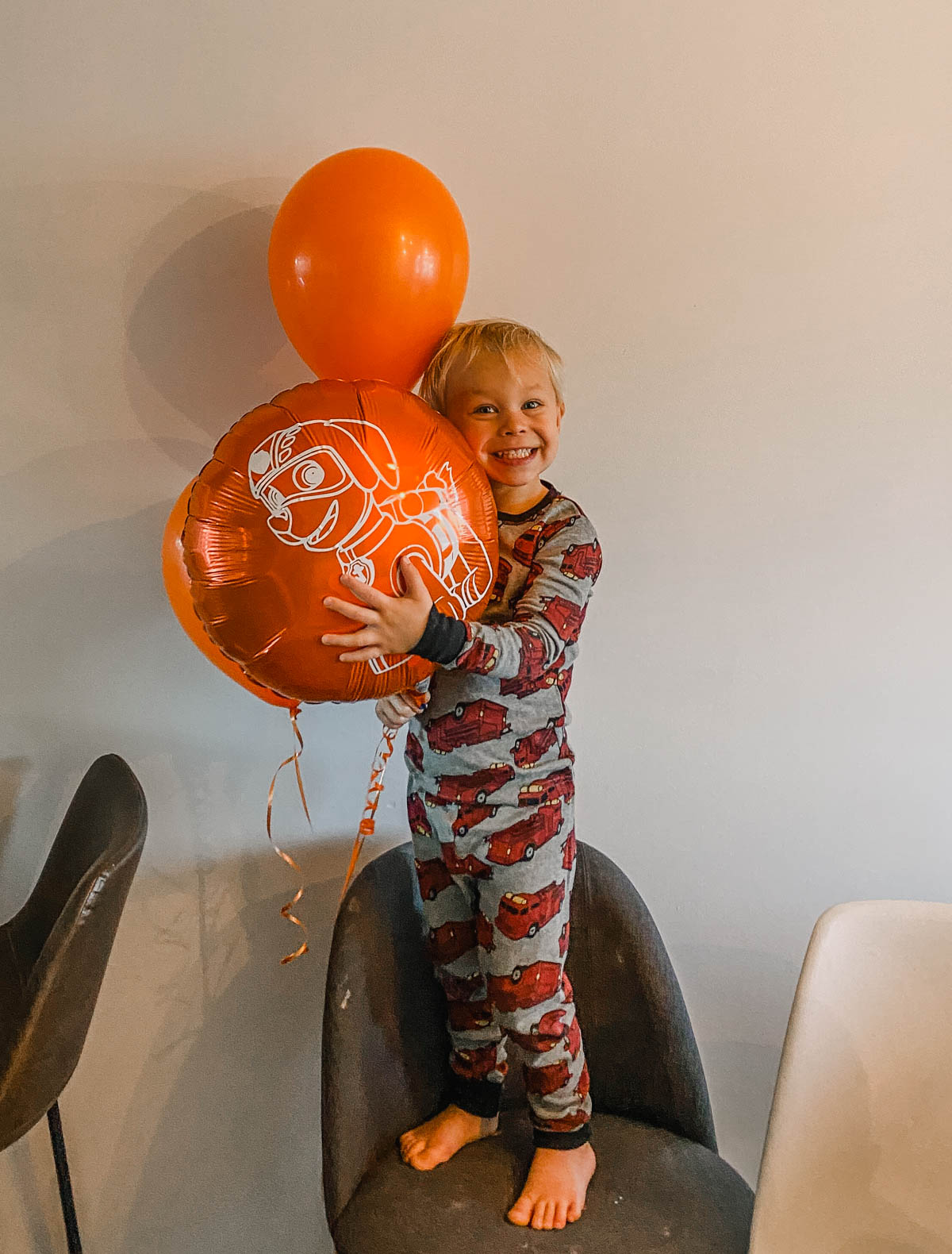 kid hugging a diy zuma balloon from paw patrol