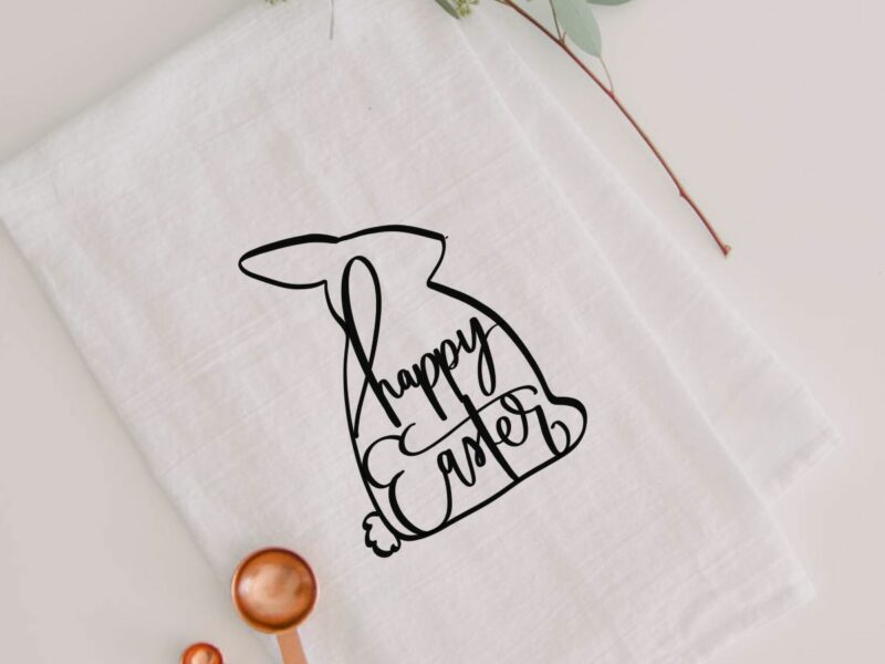 modern easter tea towel with black easter bunny silhouette and hand lettered 'happy easter'