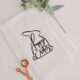 modern easter tea towel with black easter bunny silhouette and hand lettered 'happy easter'