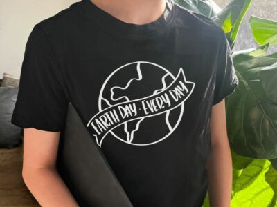 Photo of earth day black tee shirt with vinyl transfer. hand lettered 'earth day every day' design.
