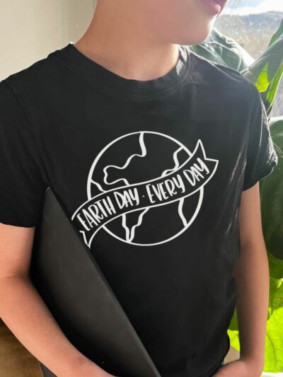 Photo of earth day black tee shirt with vinyl transfer. hand lettered 'earth day every day' design.