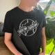 Photo of earth day black tee shirt with vinyl transfer. hand lettered 'earth day every day' design.